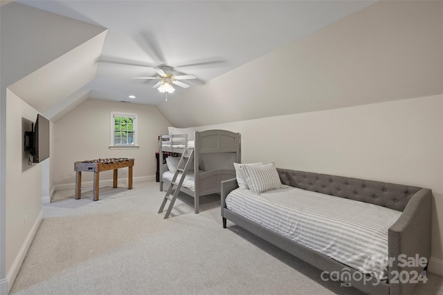 bedroom with vaulted ceiling, ceiling fan, and light colored carpet