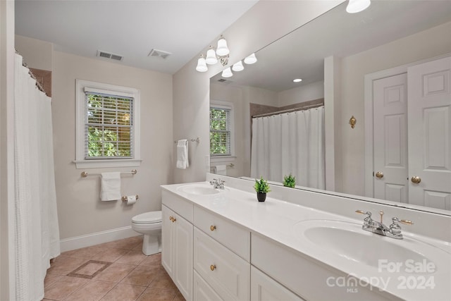 bathroom featuring tile patterned floors, vanity, and toilet