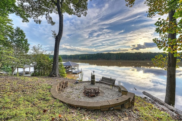 exterior space with a water view and a fire pit