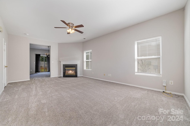 unfurnished living room with ceiling fan, light carpet, and a healthy amount of sunlight