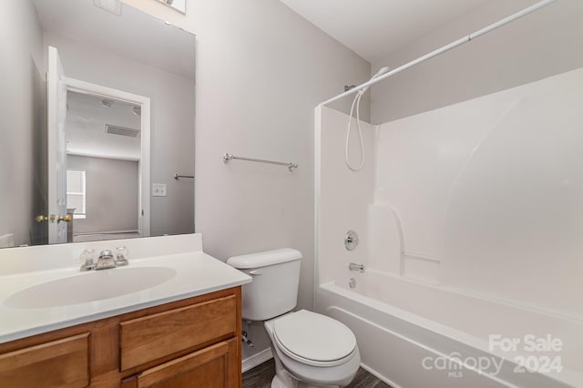 full bathroom featuring vanity, hardwood / wood-style floors,  shower combination, and toilet