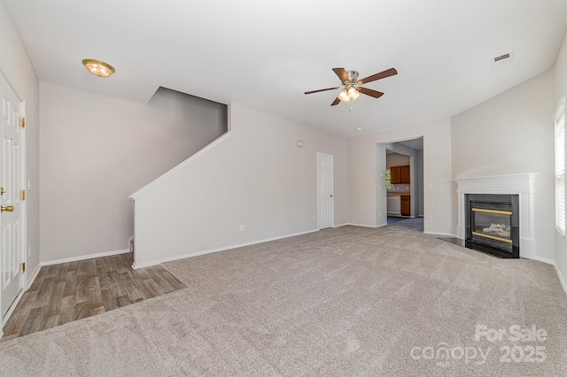 4803 Roxfield Ln, Charlotte, NC 28215 - unfurnished living room with stairway, a ceiling fan, carpet flooring, a high end fireplace, and baseboards