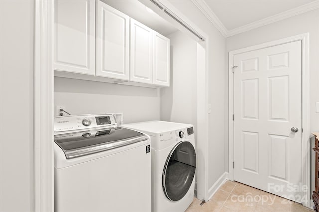 washroom with ornamental molding, washer and clothes dryer, light tile patterned flooring, and cabinets