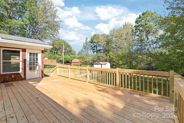 wooden deck with a storage shed