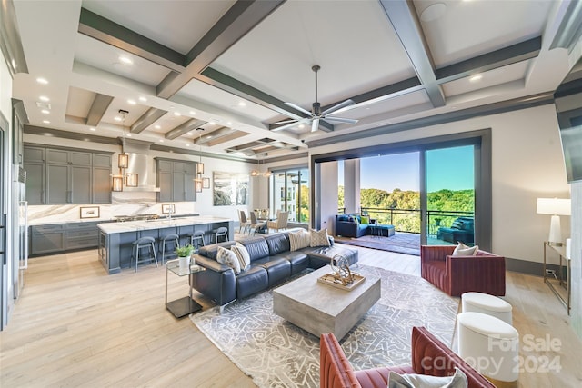 living room with coffered ceiling, beamed ceiling, light hardwood / wood-style floors, and ceiling fan