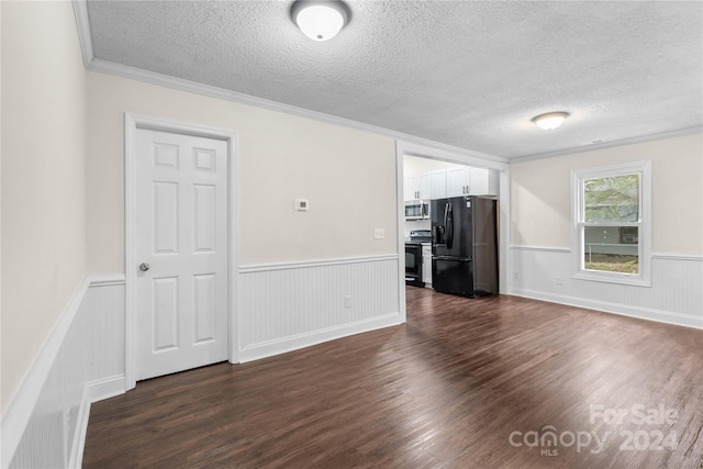 unfurnished living room featuring a textured ceiling, ornamental molding, and dark hardwood / wood-style floors