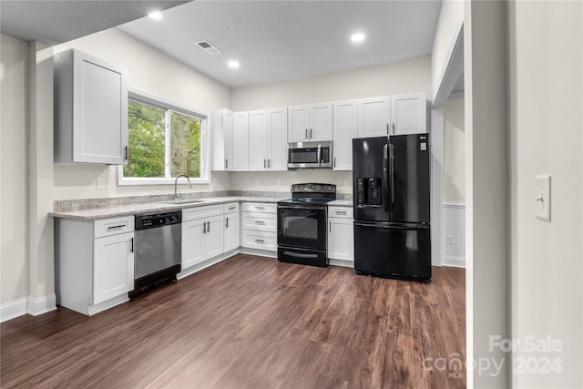 kitchen featuring white cabinets, black appliances, and dark hardwood / wood-style floors