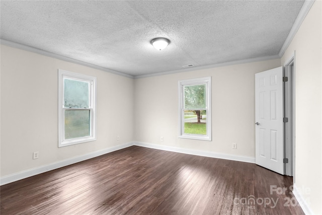 spare room with a textured ceiling, dark wood-type flooring, and crown molding