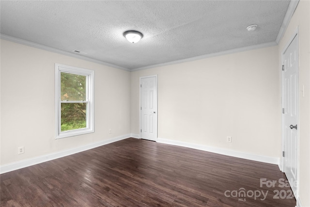 empty room with a textured ceiling, ornamental molding, and dark wood-type flooring