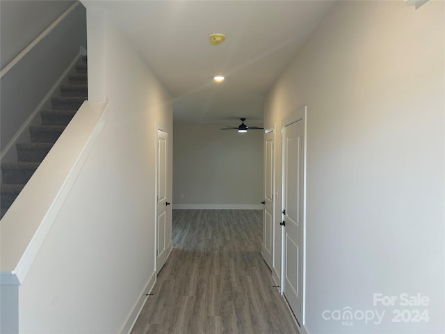 corridor with hardwood / wood-style flooring