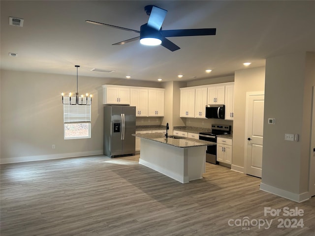 kitchen featuring appliances with stainless steel finishes, a center island with sink, white cabinetry, and wood-type flooring