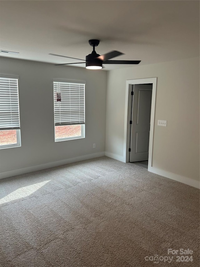 empty room with carpet and ceiling fan