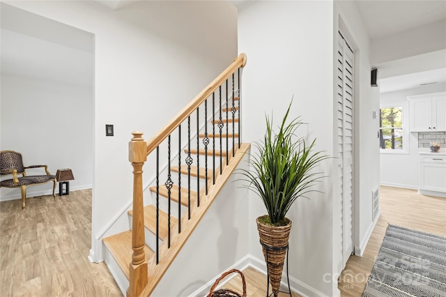 staircase featuring hardwood / wood-style flooring