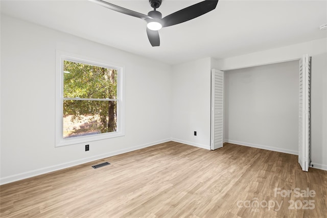 unfurnished bedroom with ceiling fan, light hardwood / wood-style floors, and a closet