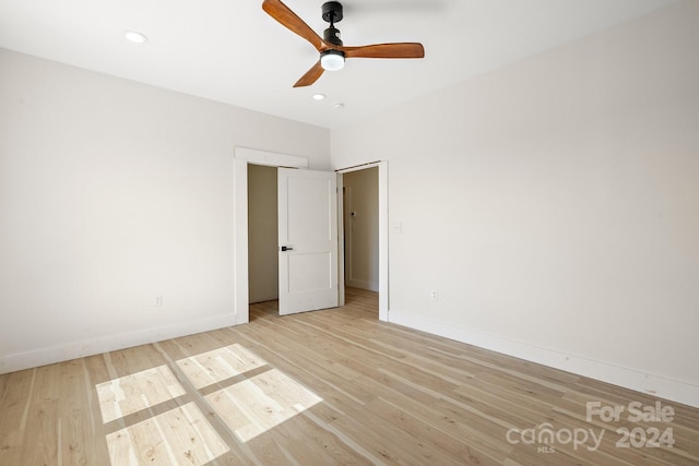 unfurnished room with ceiling fan and light hardwood / wood-style floors