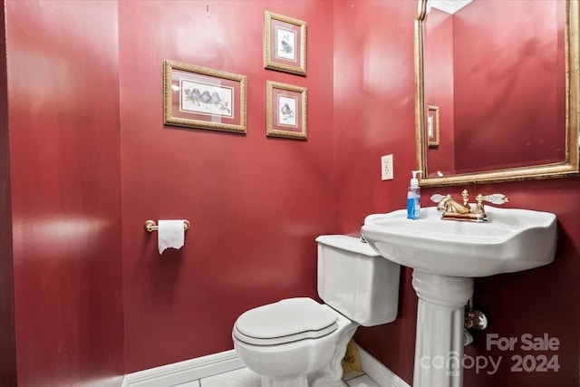 bathroom with tile patterned flooring and toilet