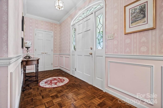 foyer featuring dark parquet flooring and ornamental molding