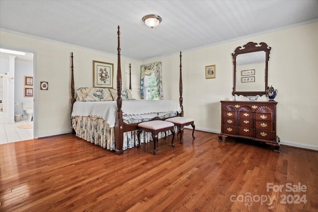 bedroom with ornamental molding and hardwood / wood-style floors