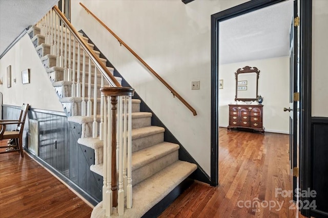 stairway featuring hardwood / wood-style flooring