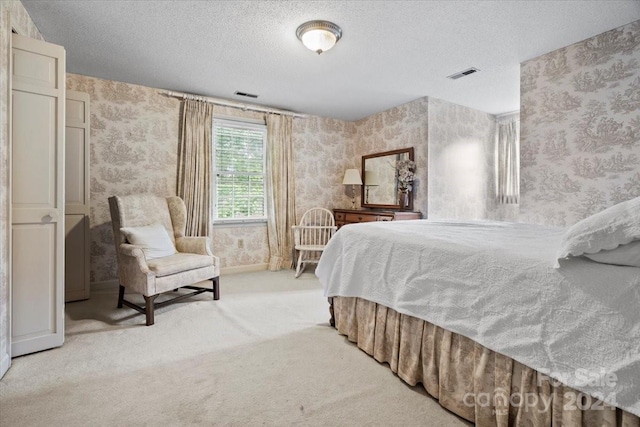 carpeted bedroom with a textured ceiling