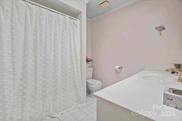 bathroom featuring vanity, tile patterned floors, ornamental molding, toilet, and a textured ceiling