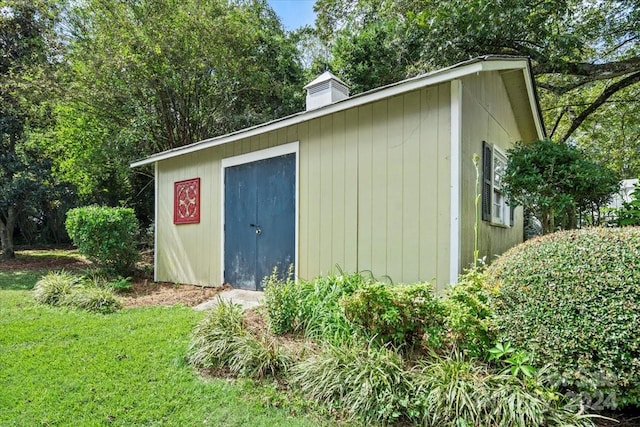 view of outbuilding with a lawn