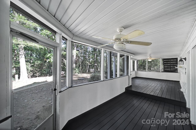 unfurnished sunroom featuring a wealth of natural light and ceiling fan