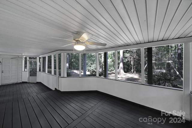 unfurnished sunroom with ceiling fan