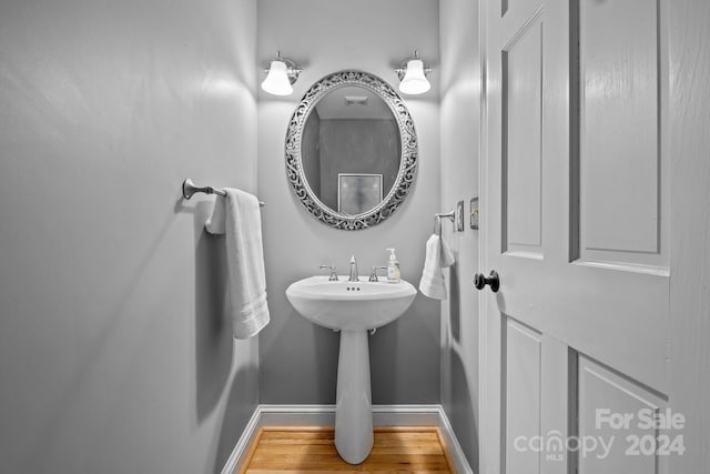 bathroom with hardwood / wood-style flooring