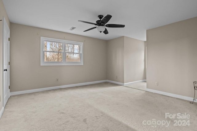 unfurnished room featuring ceiling fan and light carpet