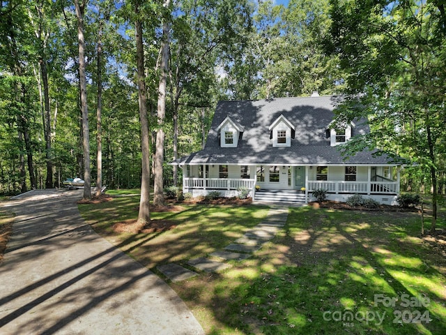 view of front of house with a front yard and a porch