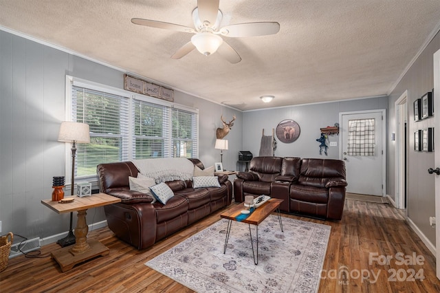 living room featuring ornamental molding, hardwood / wood-style flooring, a textured ceiling, and ceiling fan