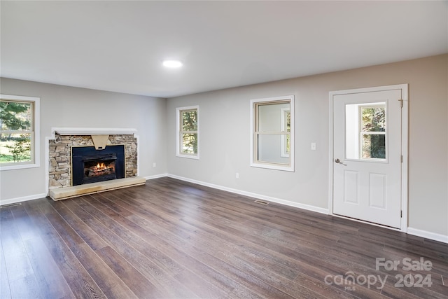 unfurnished living room featuring a fireplace and dark hardwood / wood-style flooring