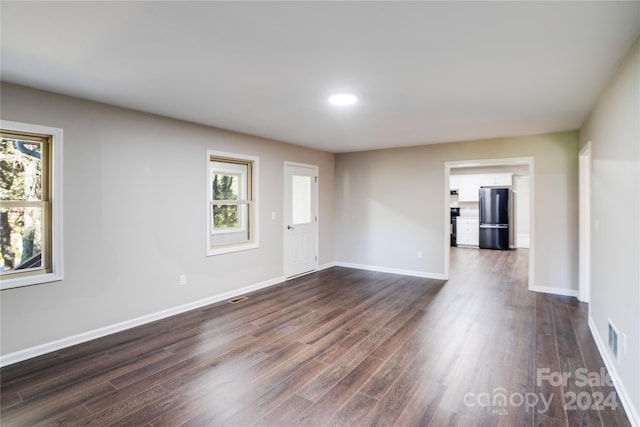 empty room featuring dark hardwood / wood-style floors and a wealth of natural light