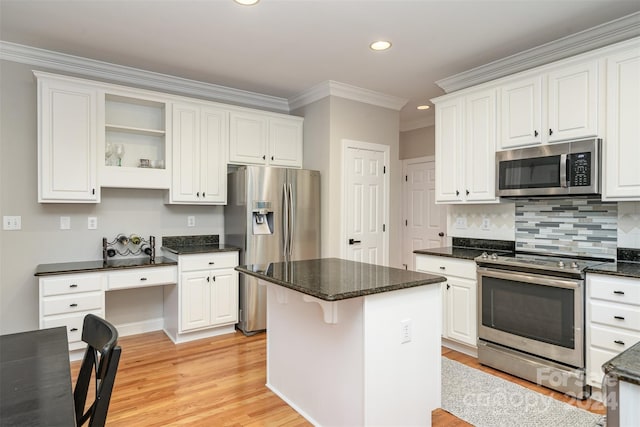 kitchen with a kitchen island, white cabinetry, and appliances with stainless steel finishes