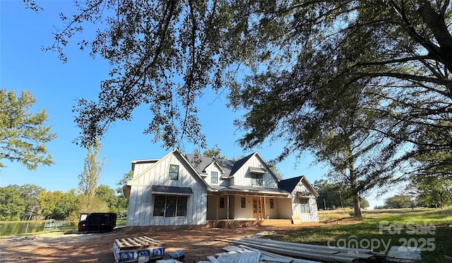 modern farmhouse style home with a porch and board and batten siding