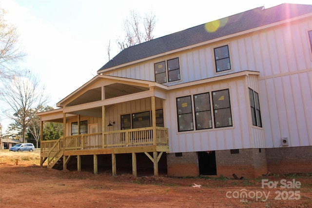 rear view of property with crawl space, covered porch, board and batten siding, and a shingled roof