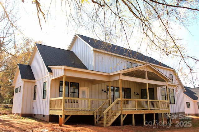 rear view of house with board and batten siding, roof with shingles, and crawl space