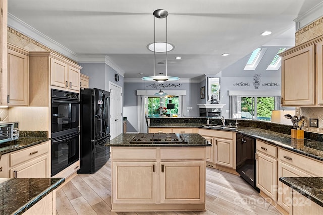 kitchen with light wood-type flooring, black appliances, pendant lighting, a skylight, and light brown cabinetry