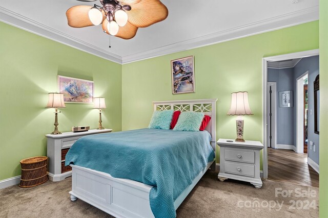 bedroom featuring ceiling fan, carpet flooring, and ornamental molding