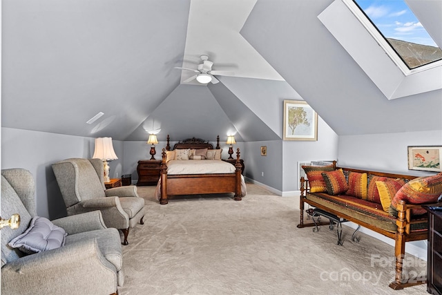 carpeted bedroom featuring ceiling fan, lofted ceiling with skylight, and multiple windows