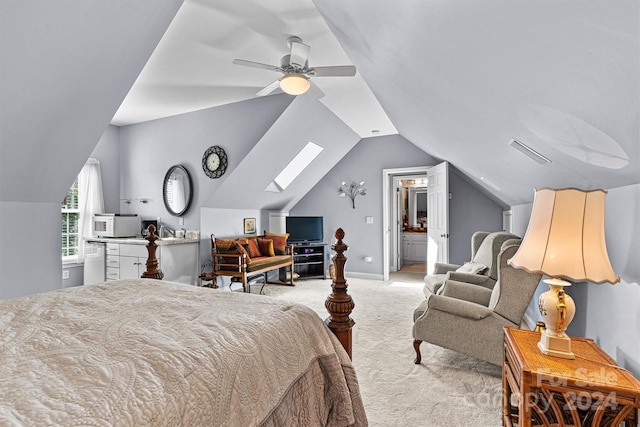 bedroom featuring ceiling fan, visible vents, lofted ceiling with skylight, and light colored carpet