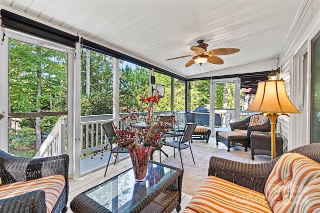 sunroom / solarium featuring ceiling fan, vaulted ceiling, and a healthy amount of sunlight