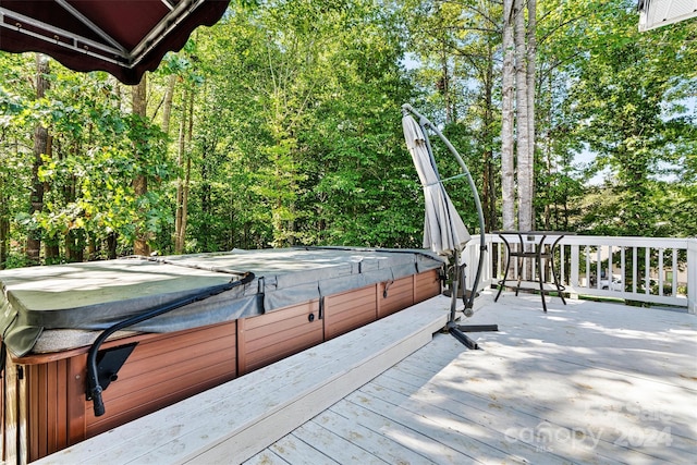 wooden terrace featuring a hot tub