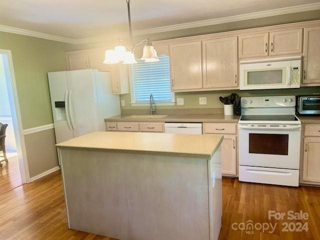 kitchen featuring an inviting chandelier, a sink, white appliances, a center island, and a toaster