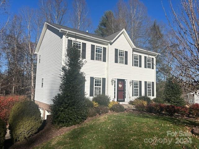 colonial home with a front lawn