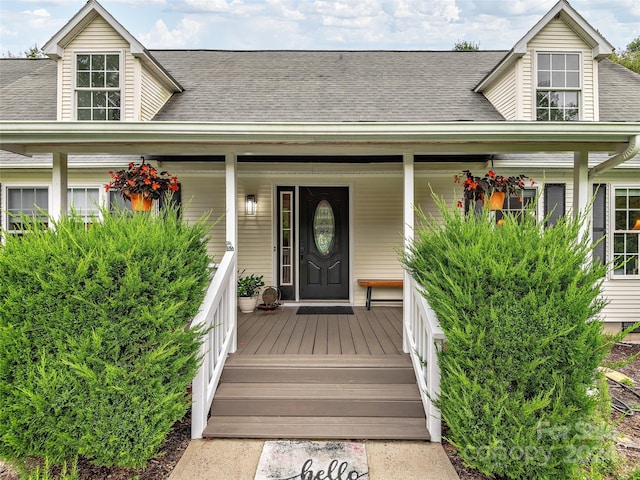 view of exterior entry with a porch