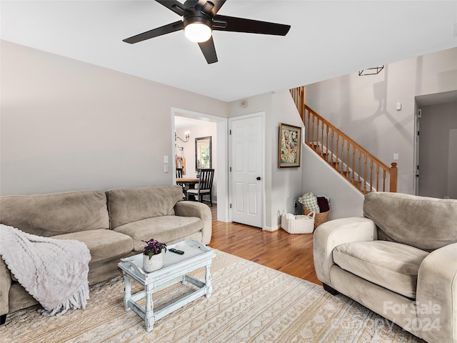 living room featuring ceiling fan and hardwood / wood-style flooring