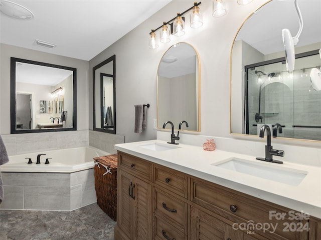 bathroom featuring vanity and separate shower and tub