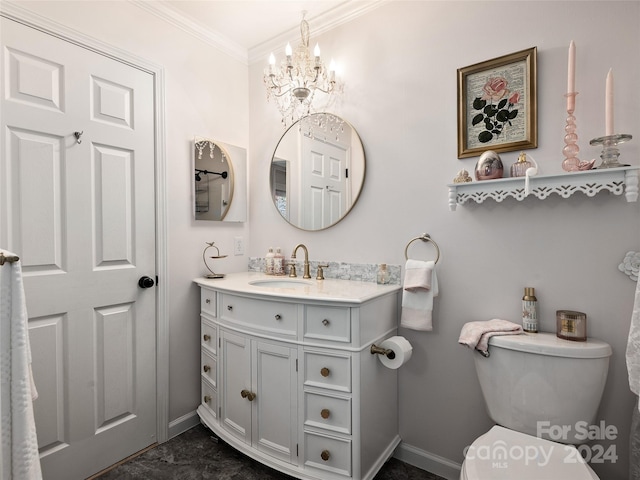 bathroom with ornamental molding, vanity, and toilet